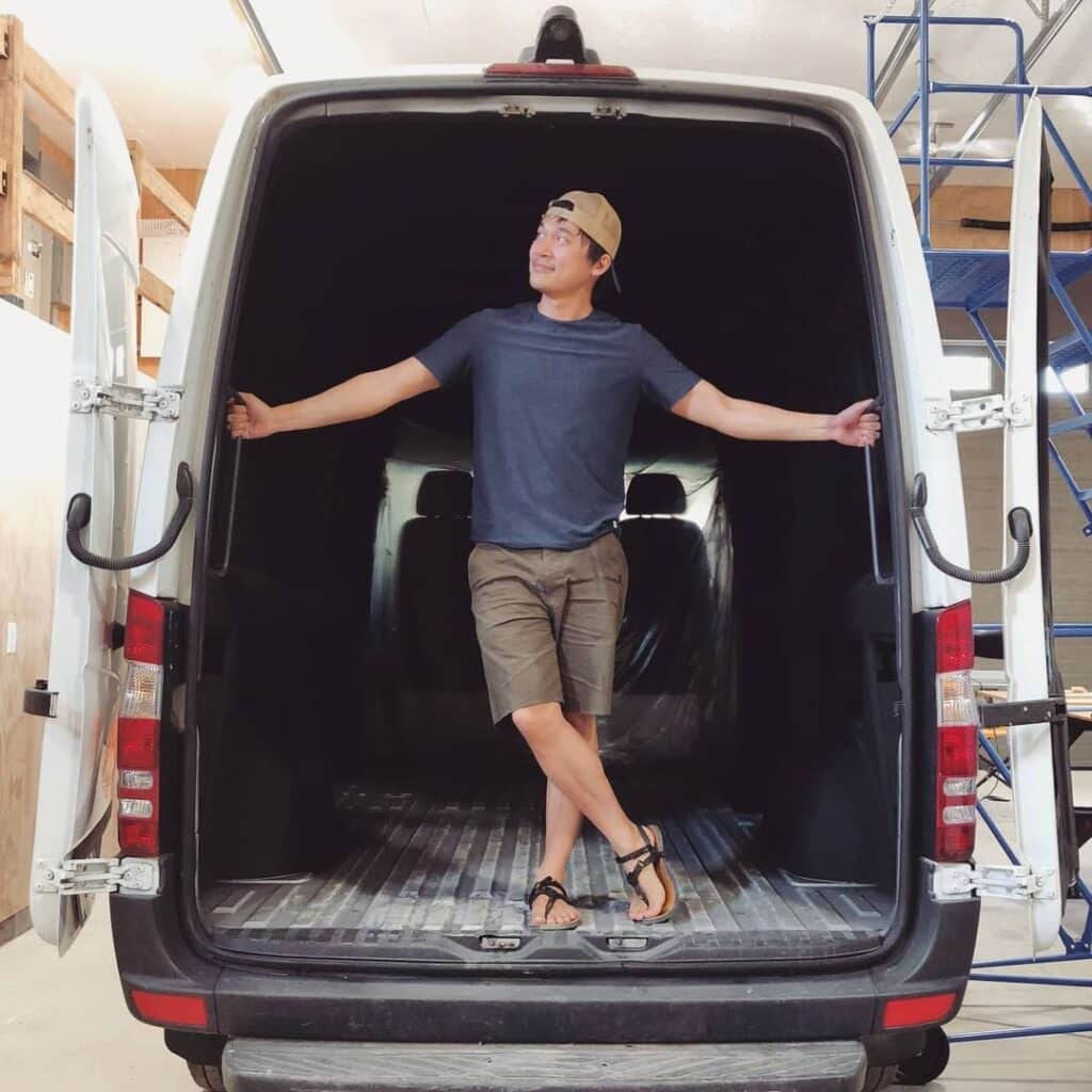 @yukonvan man standing at the back door of a van, sprinter van home conversion