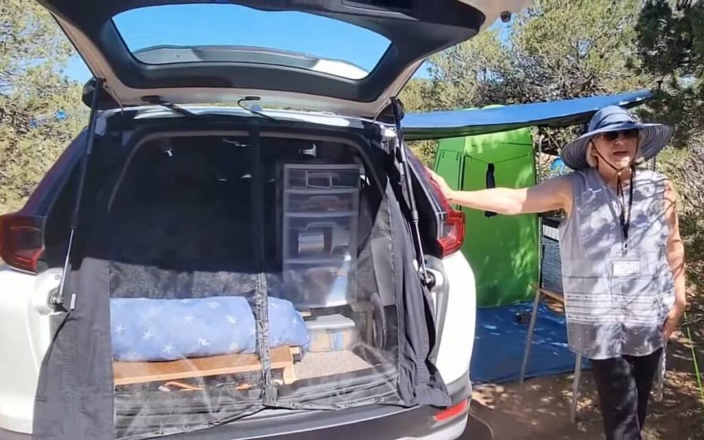 Clara showing the interior of her camper suv