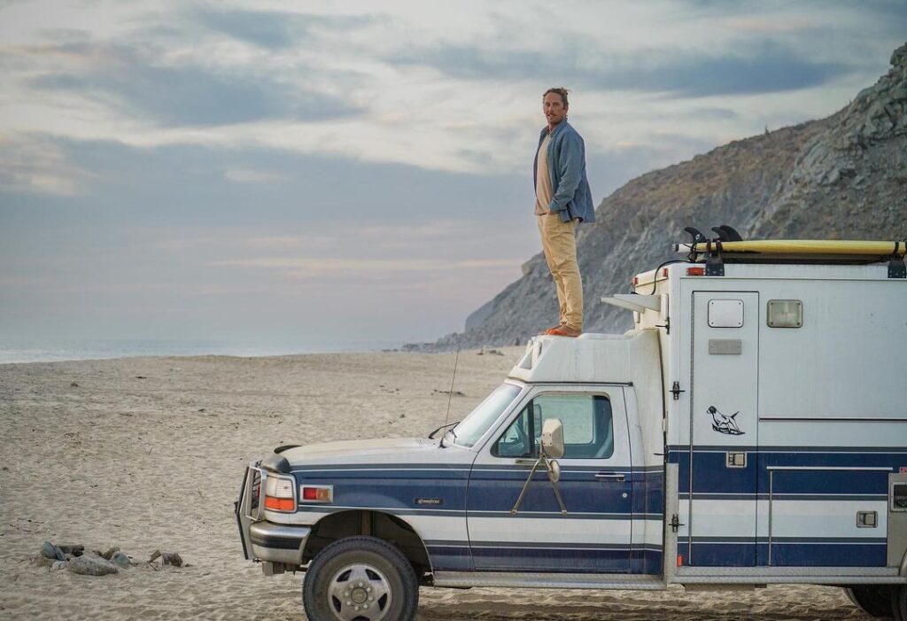 @adventure_ambo Young man standing on the roof of ambulance conversion