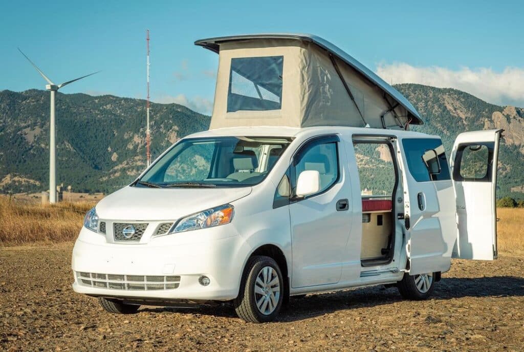 @contravans White nissan nv200 camper parked in a field near a wind turbine