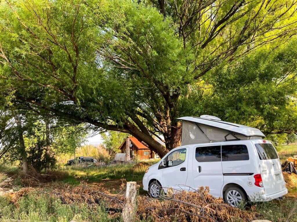 @gtrvvans White nissan nv200 campervan parked under a tree