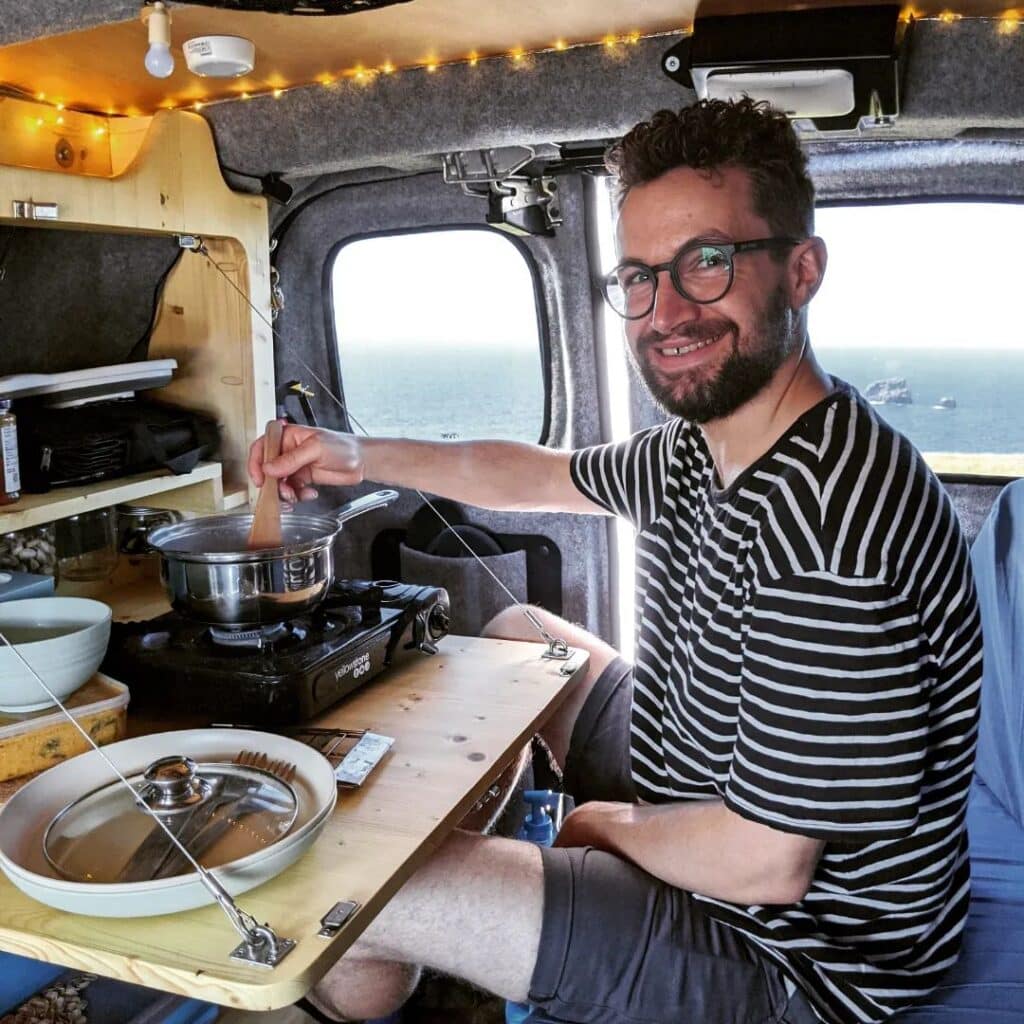 @yogi.the.van Man cooking in his van