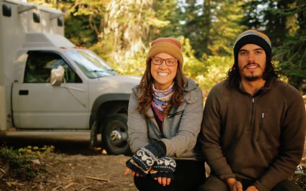 Carl and Maddie sitting and talking with their vanning rig in the background