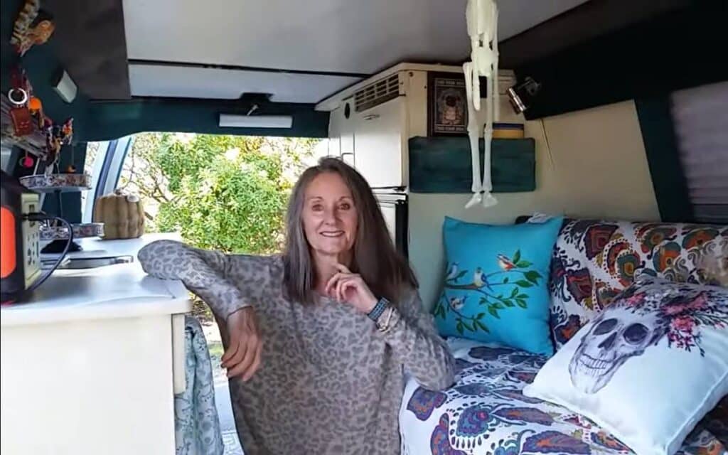 Glippie sitting comfortably inside her ford econoline camper