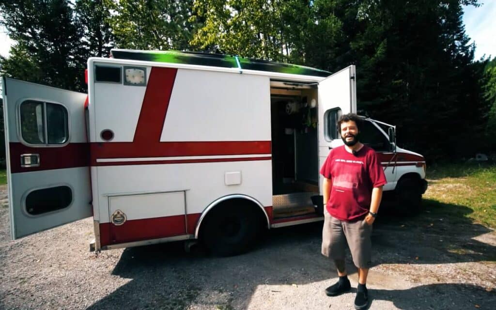 Josh standing next to his van life rig