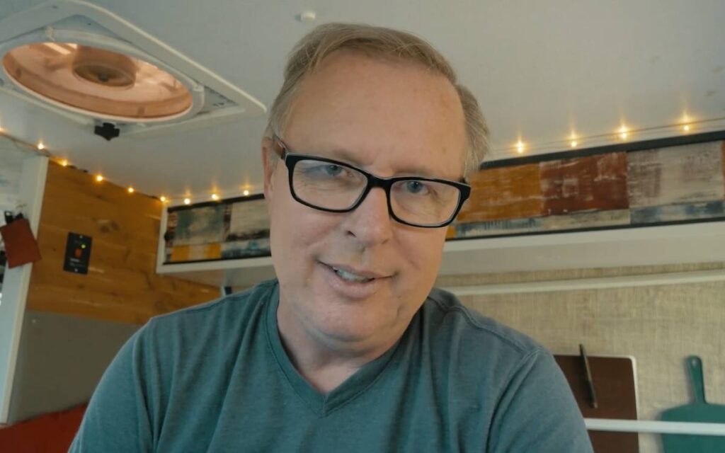 Tim sitting inside his ford e series camper van