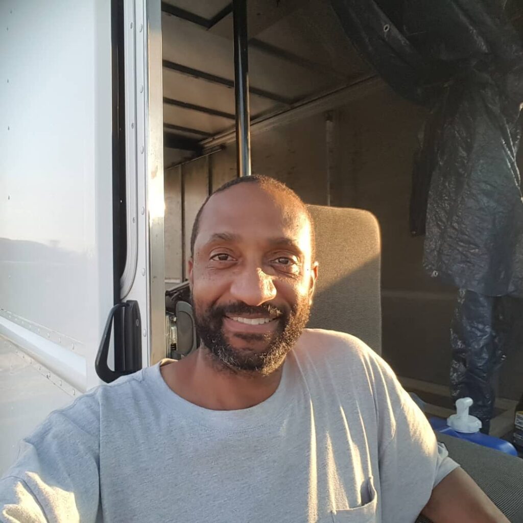 @lamontzenki Man taking a selfie next to his box truck camper@lamontzenki Man taking a selfie next to his box truck camper