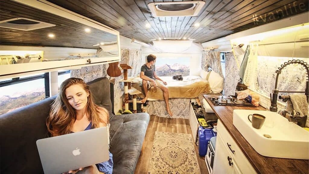 @livingzeal Young couple relaxing inside their short bus conversion