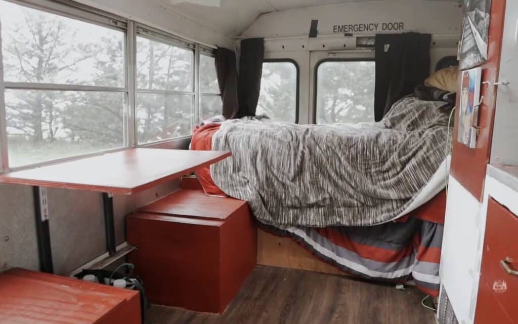 Bed inside a short bus conversion