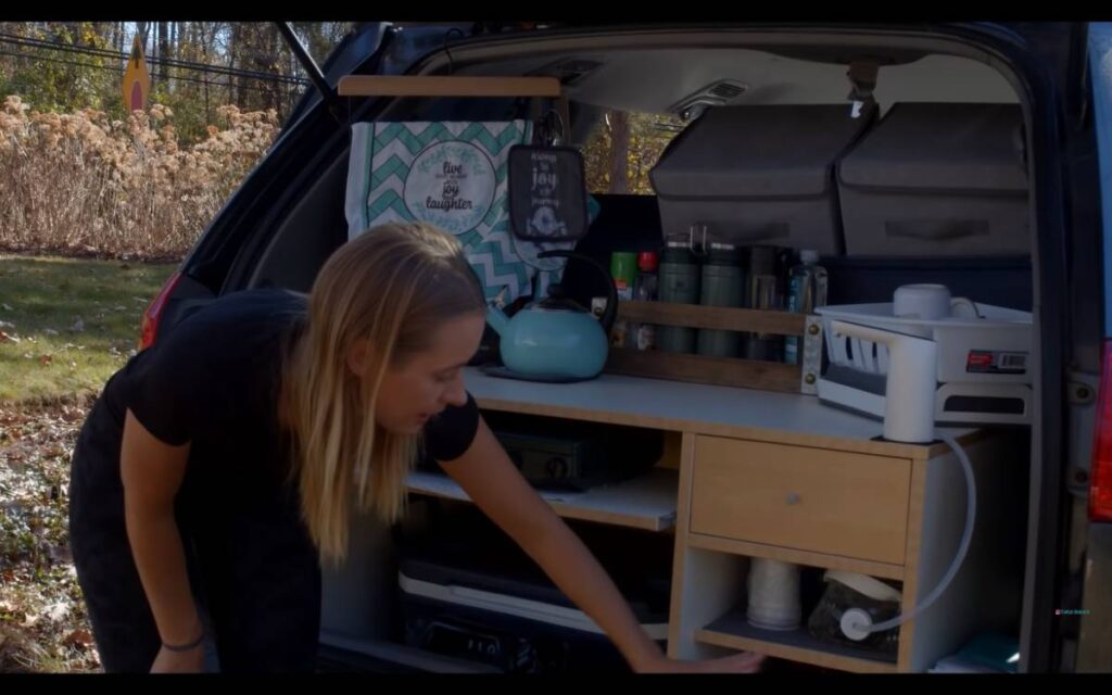 @thegymnomads Emelia giving a tour of their Toyota Sienna camper conversion kitchen