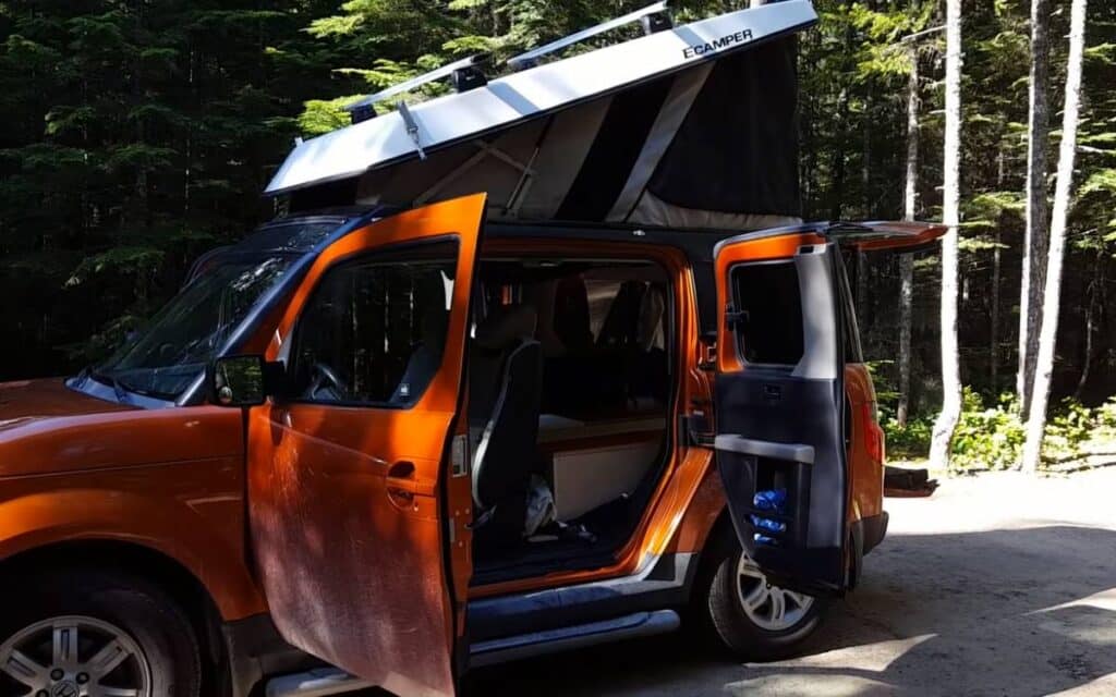 Charis' honda element camper side view shot with pop-up tent set up and doors opened