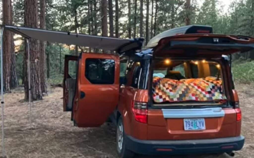 Christina's honda element camper conversion, back shot with doors opened and an awning on the left side