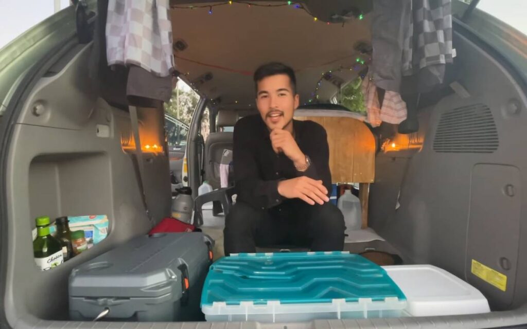 Jimmy sitting inside his Toyota Sienna campervan