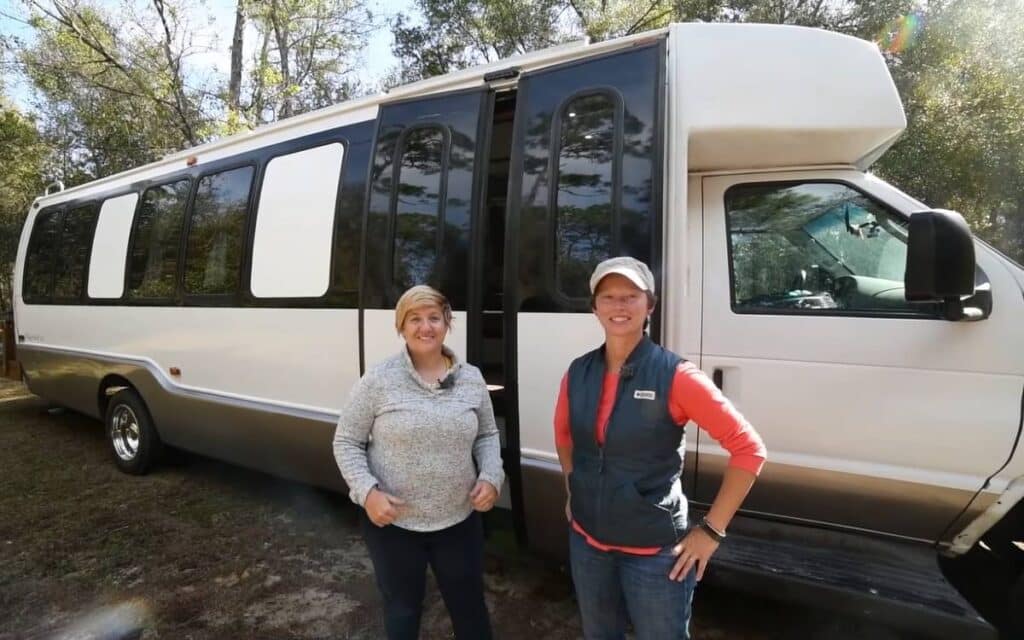 @thesolbus Stephanie and Sara showing their shuttle bus conversion with white and black exterior paint