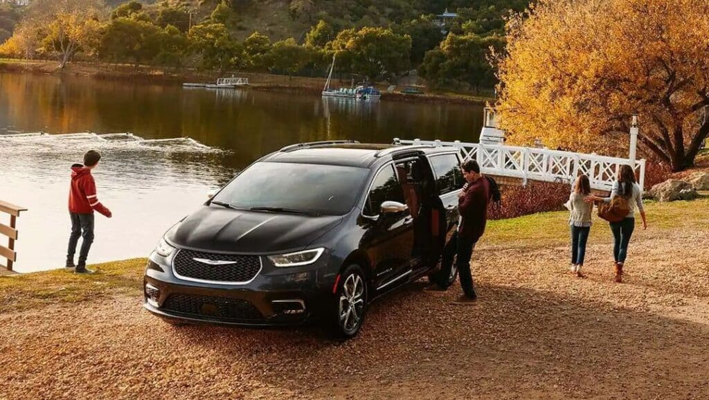 Black Chrysler Pacifica car parked by a lake