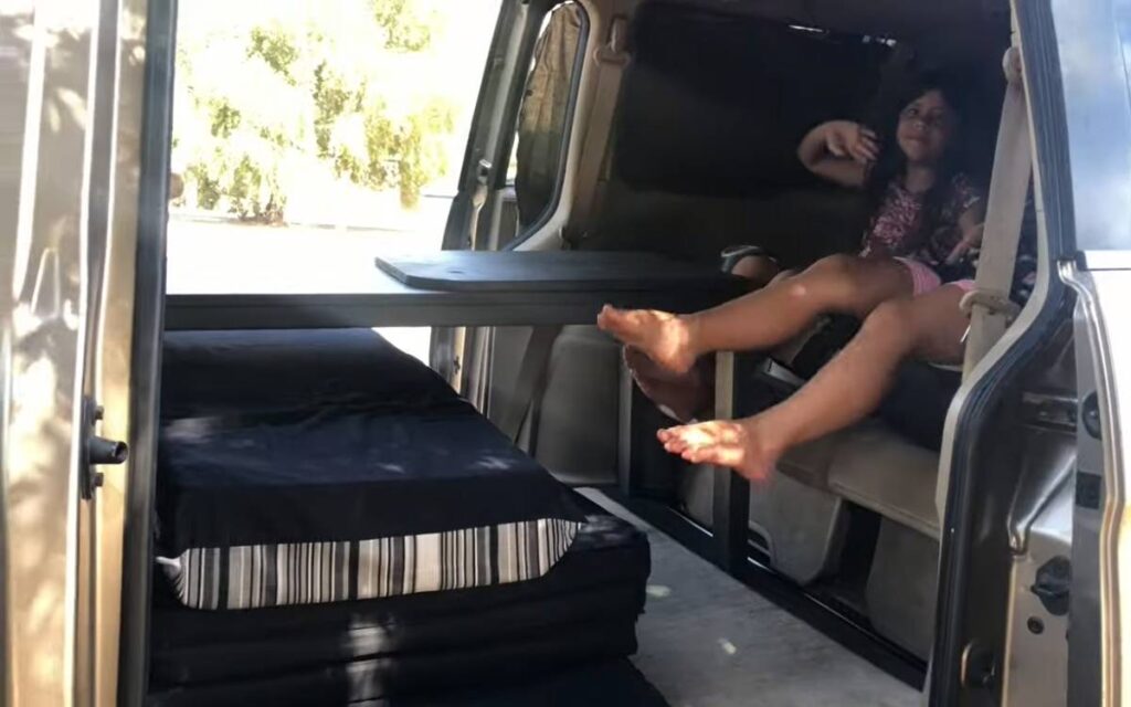 Fabio's camper with his two daughters sitting inside