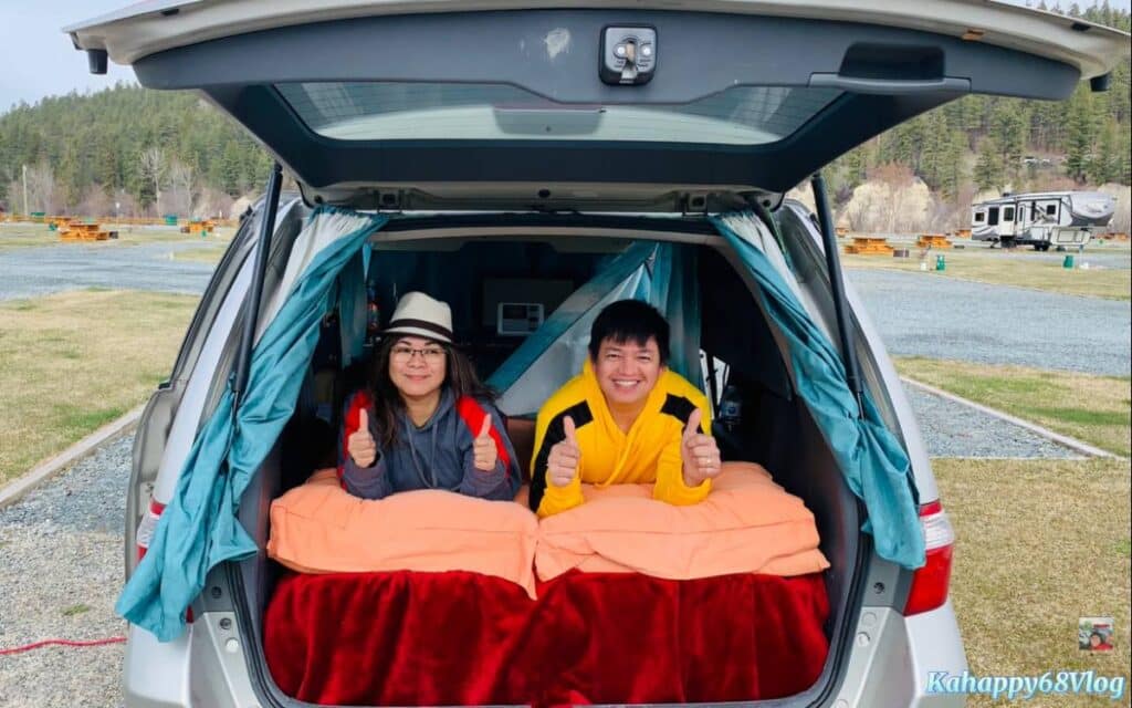 Kahappy68 Vlog Couple lying on bed inside their car turned into camper