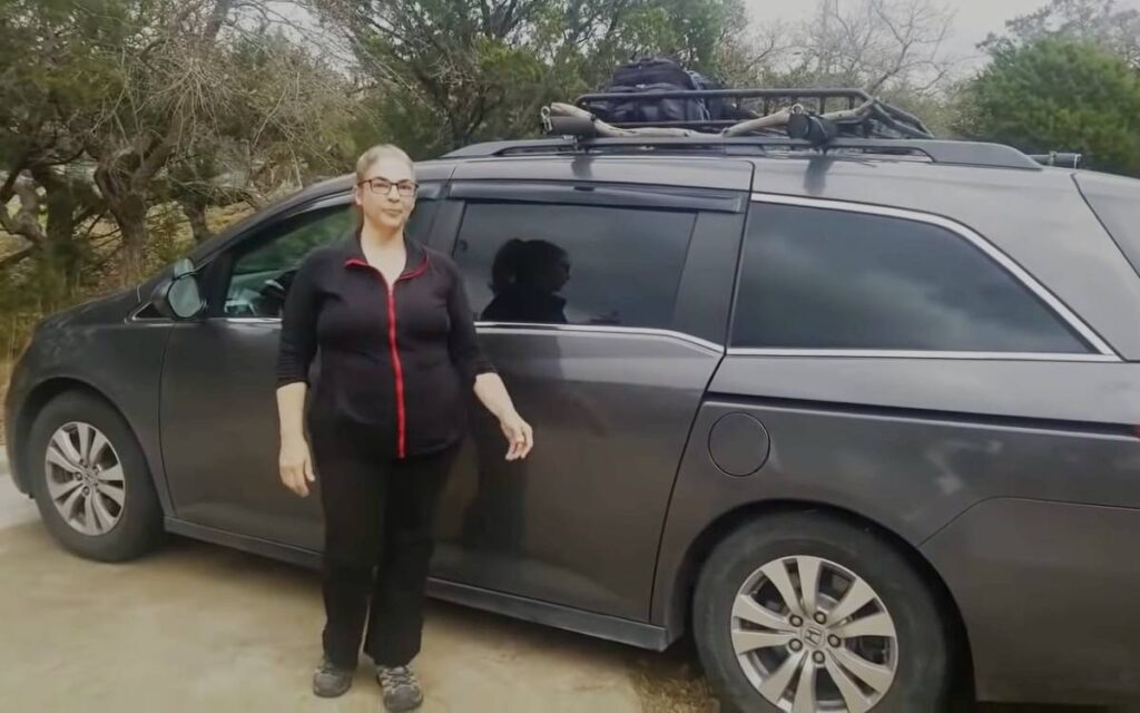 Leslie standing next to her car