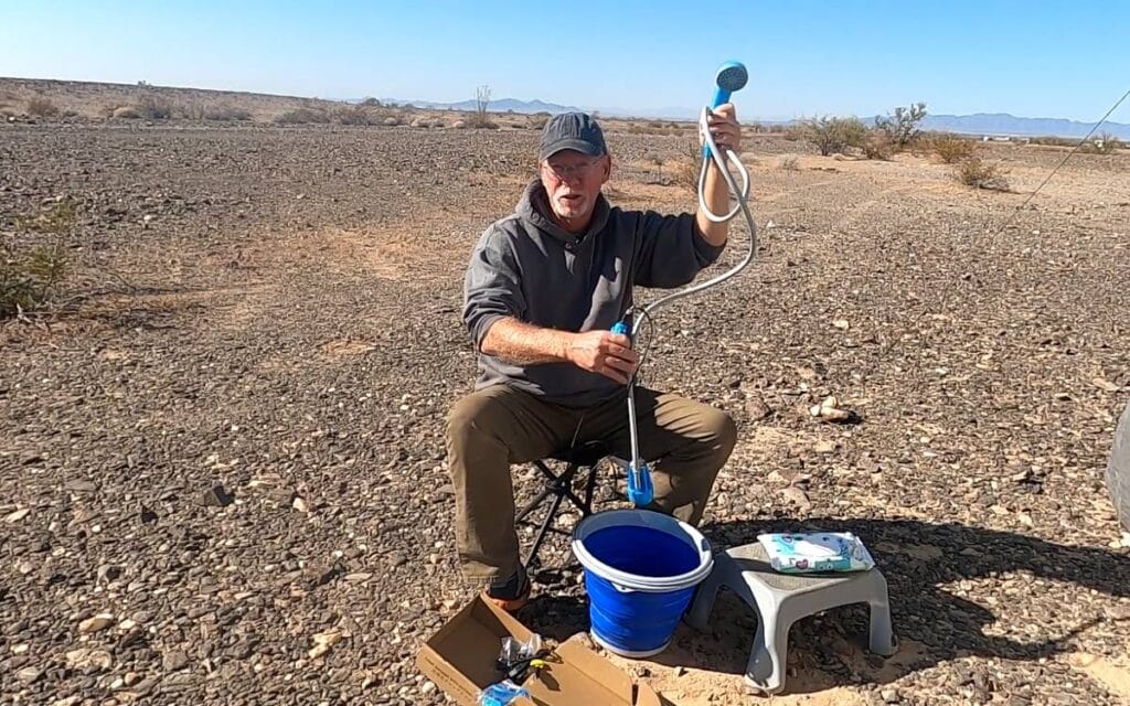 Man showing off his portable shower