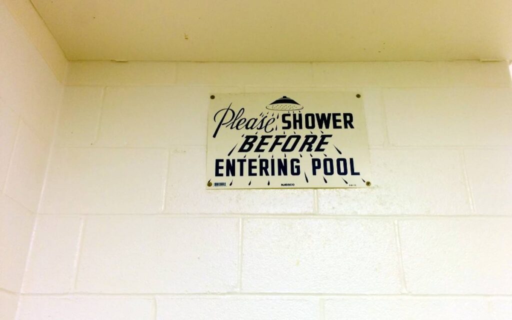 Please shower before entering pool sign on the wall