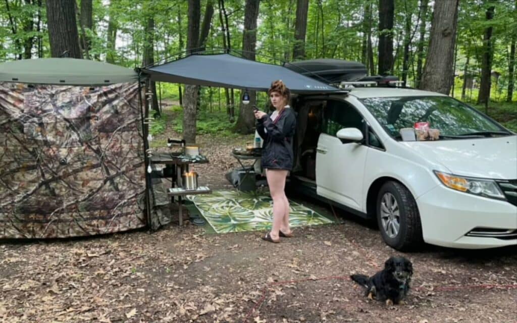 Sherry standing beside her white camper van