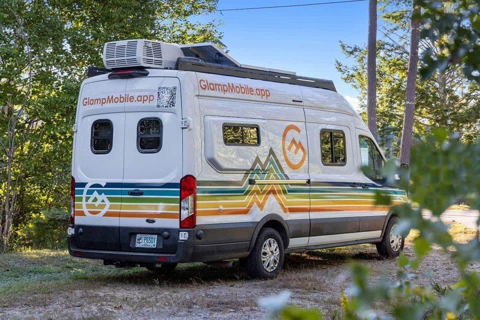 @able_beerable_beer luxury camper van with colorful exterior paint parked near trees
