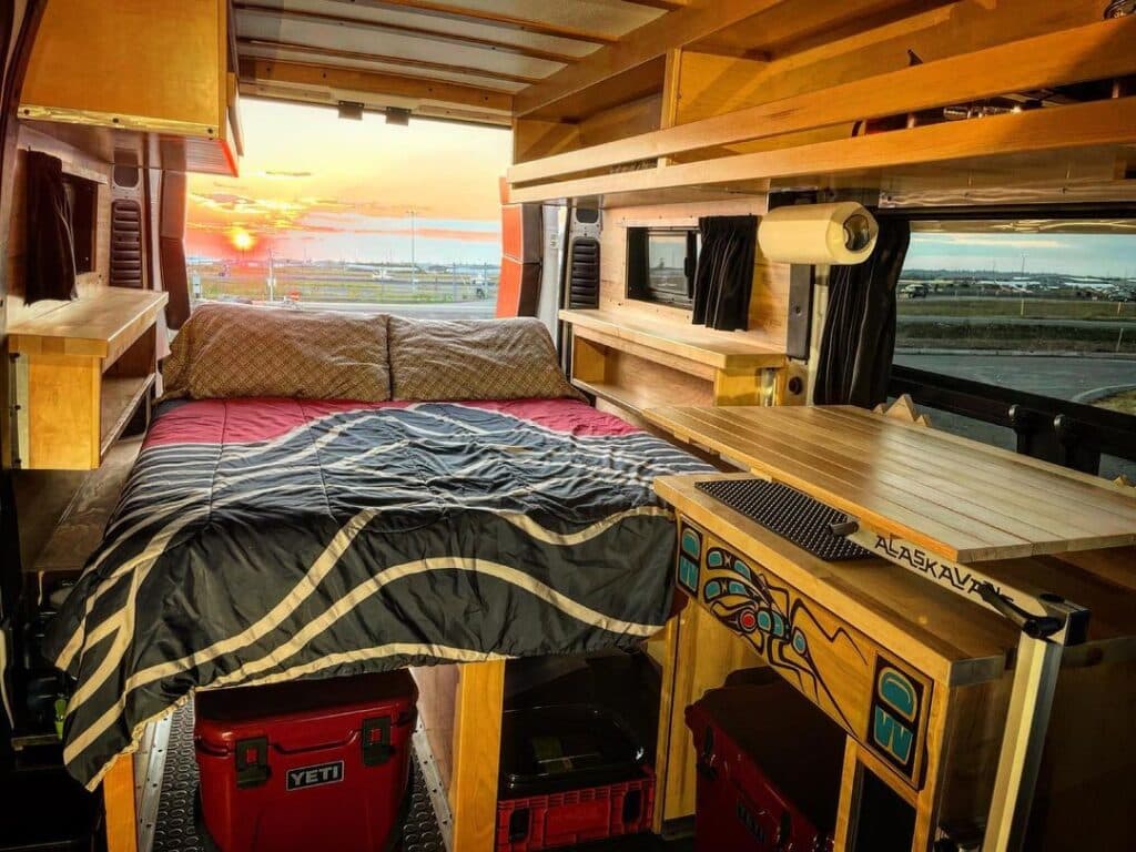 @alaskavans campervan rentals camper van interior and sunset view from open back door