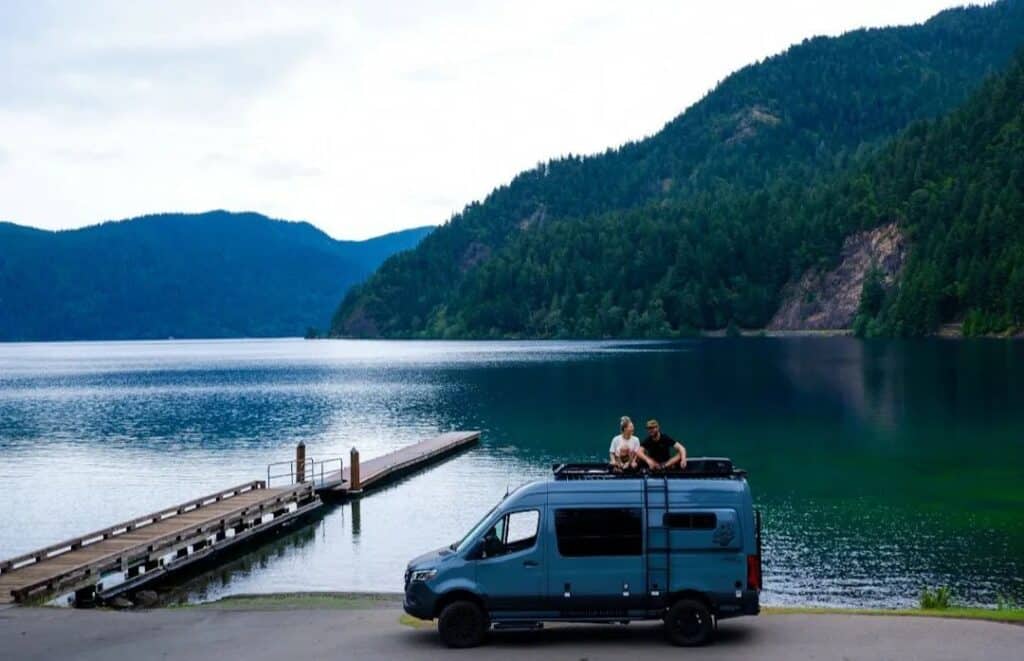 @bendadventurevans A family of three camping near lake in a storyteller overland camper from Bend Adventure Vans campervan rentals