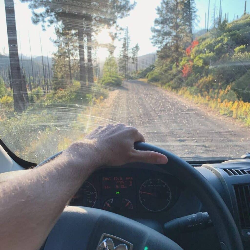 @dillythevan Male hand on the steering wheel of a large van, driver's point of view