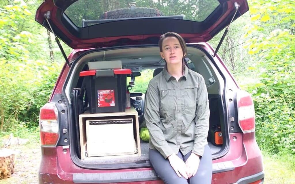 @eldantzler subaru forester camper conversion, El sitting at the back of her red campervan