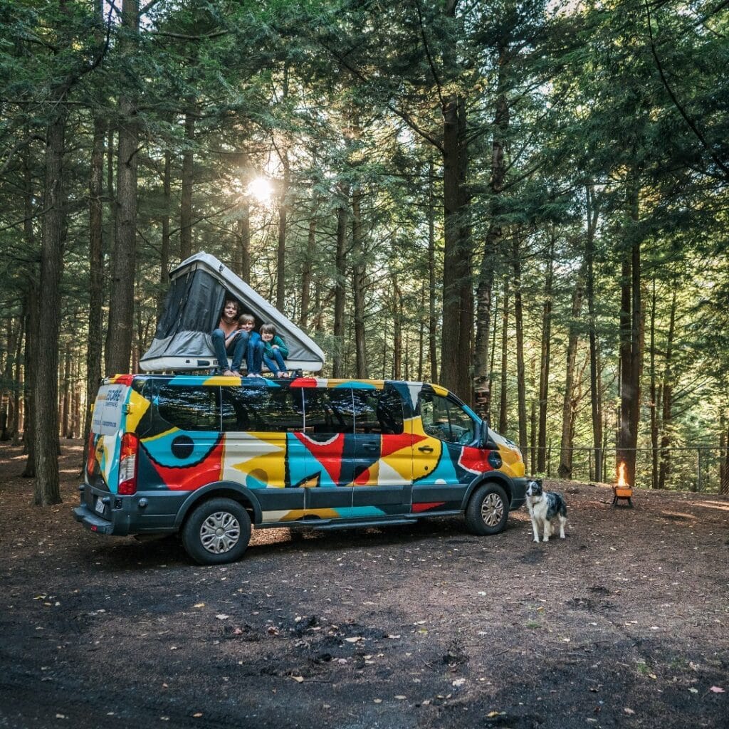 @escapecampervans A happy family van camping in the forest with Escape Campervans campervan rentals