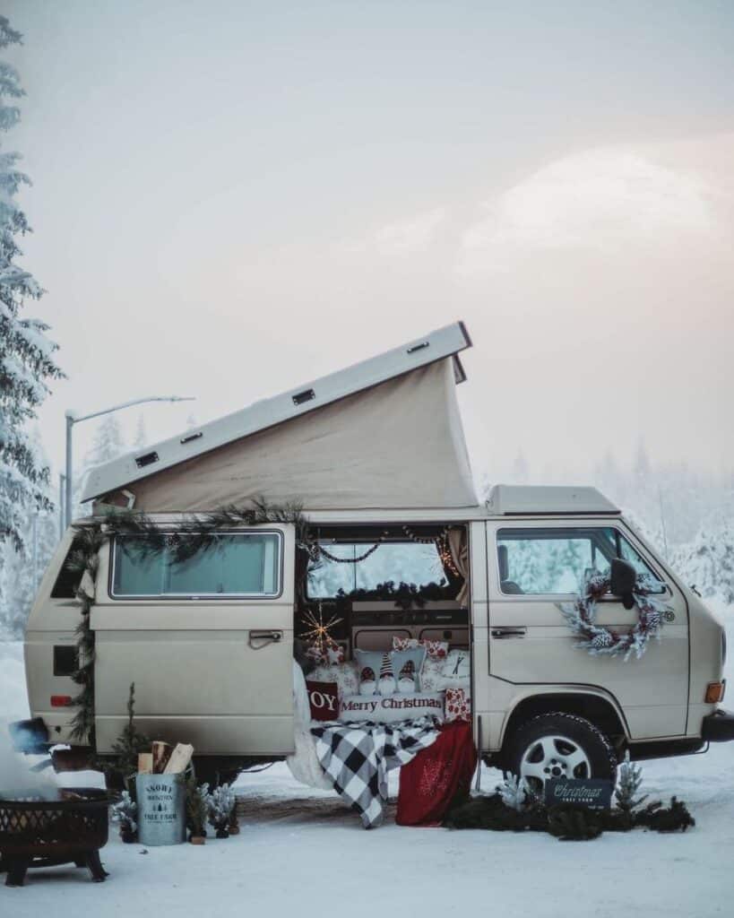 @last_frontier_westys campervan rentals VW T3 camper adorned with Christmas ornaments parked in snow