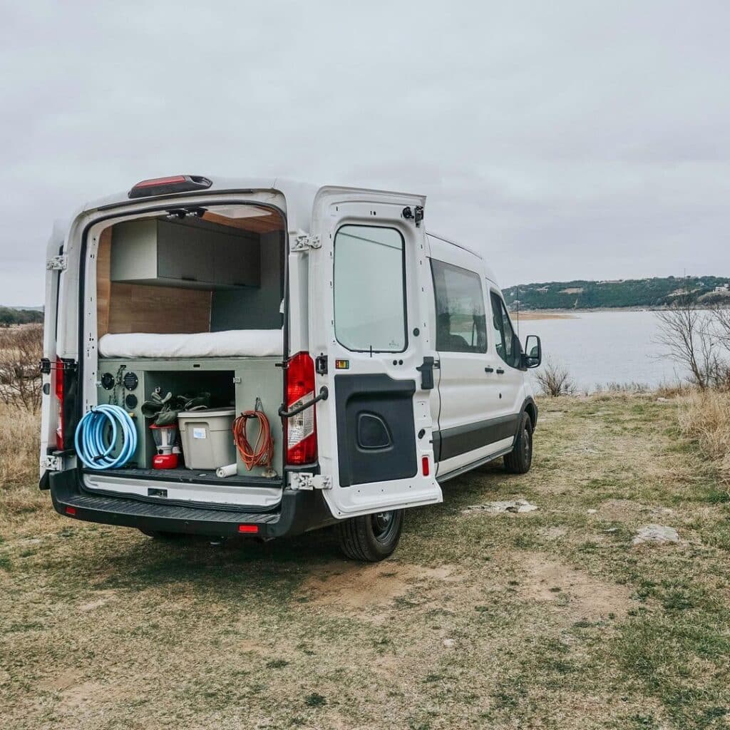 @navigo.life campervan rentals camper parked near body of water