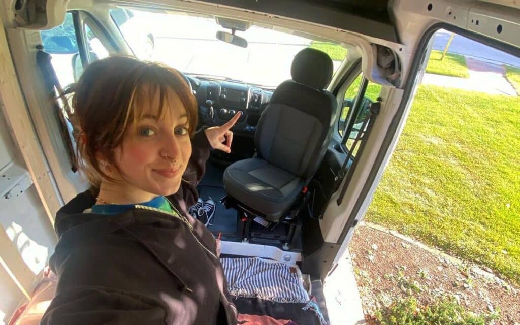 @promastermommy Van dweller pointing at the newly installed swivel seat inside her campervan