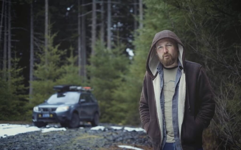 @softroadingthewest Donald standing in the woods with his subaru forester camper conversion in the background