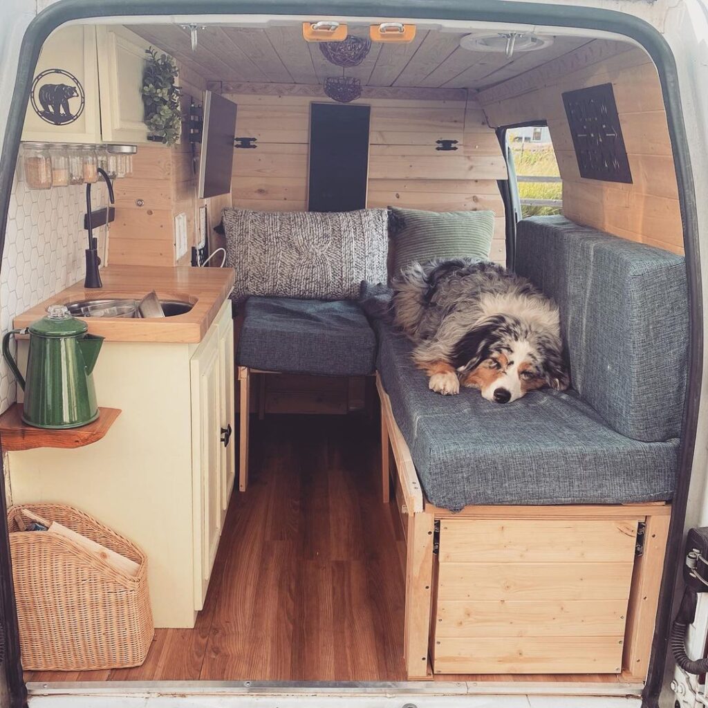 @milomeloy Dog sleeping on a sofa bed inside a campervan