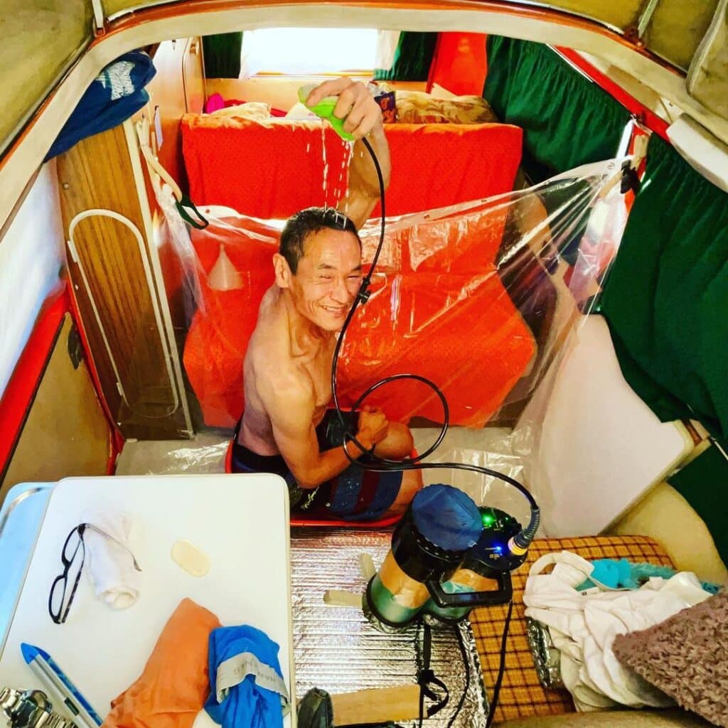 @nomad_vanlifer Happy man showering inside his VW camper