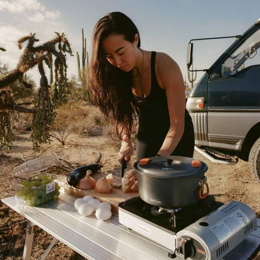 @sophiehilaire Van dweller woman cooking outside her camper van