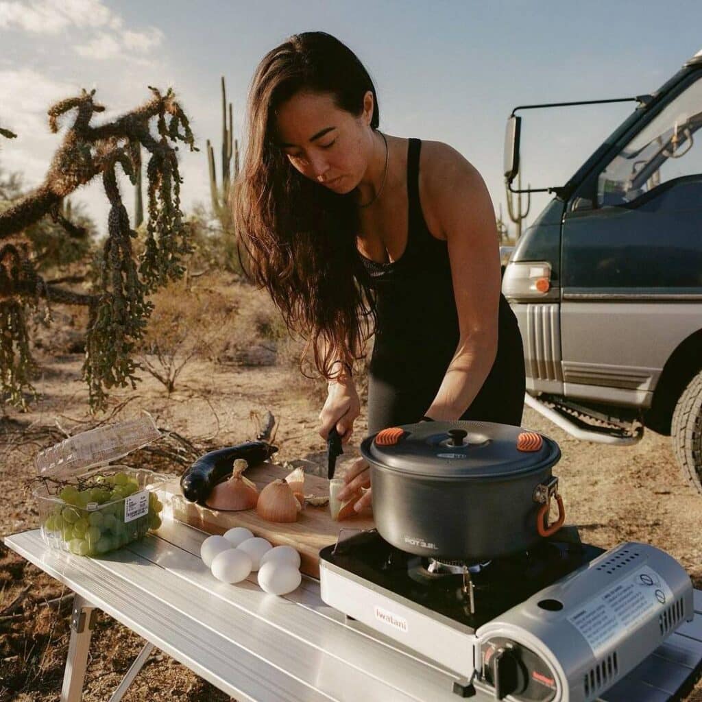 https://gnomadhome.com/wp-content/uploads/2023/02/@sophiehilaire-Van-dweller-woman-cooking-outside-her-camper-van-1024x1024.jpg