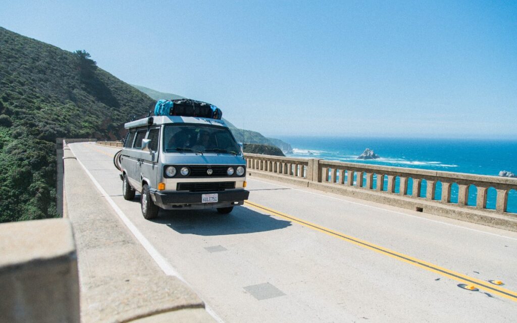 Campervan crossing a bridge over a body of water