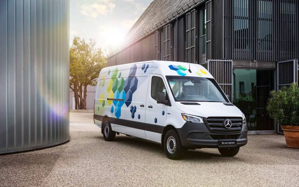 White Mercedes Benz electric van parked near a building