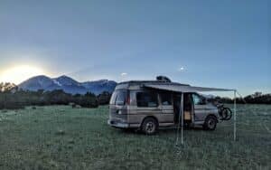 Camper van posted up in front of some picturesque mountains