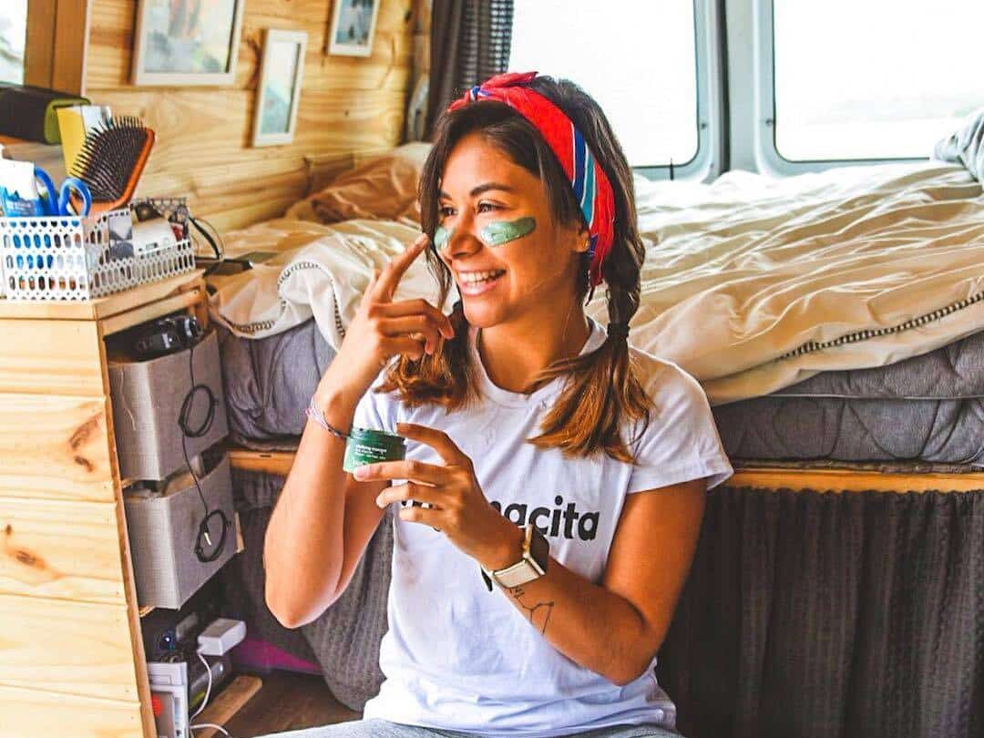 @anaalarcon Smiling woman inside her camper van enjoying vanlife 