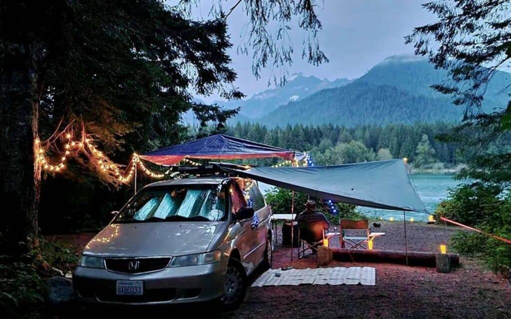 @campervanblanche Man camping in a minivan in Baker lake