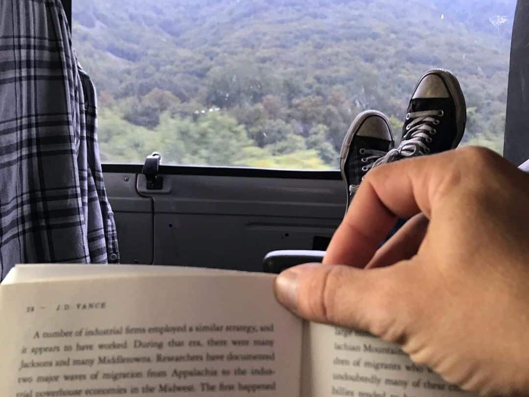 @chrisrattieandthenewrebels POV of a man reading a book inside his van