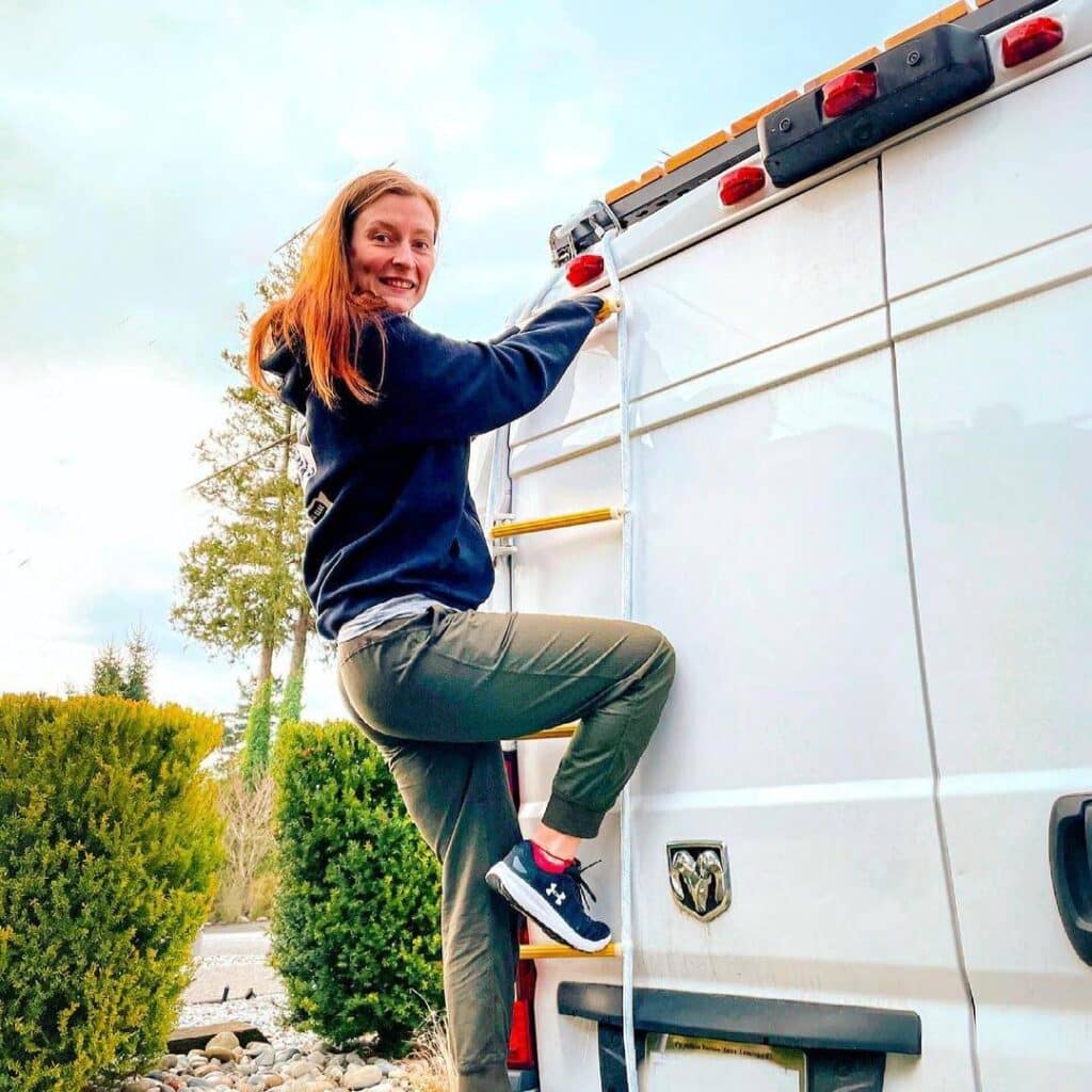 @hayleyandjake Happy woman climbing on van ladder