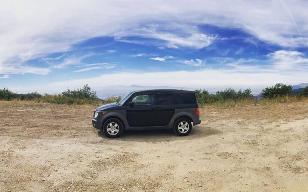 @hondaelementcamper Black Honda element campervan parked in a secluded spot high in the mountains