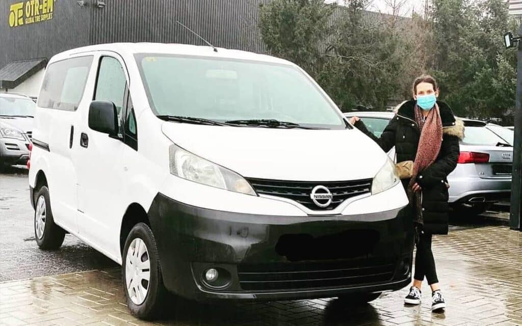 @sagi_nv200 Woman standing next to her newly bought white nv200 minivan