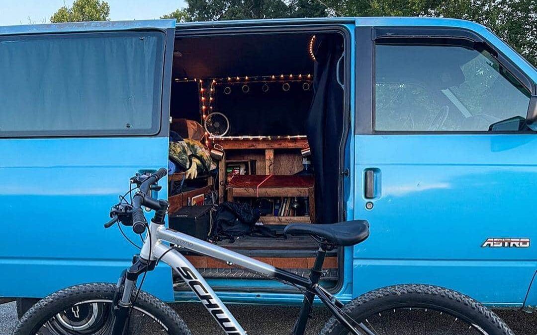 @the_ethnic_explorer Blue chevy astro van parked next to a mountain bike
