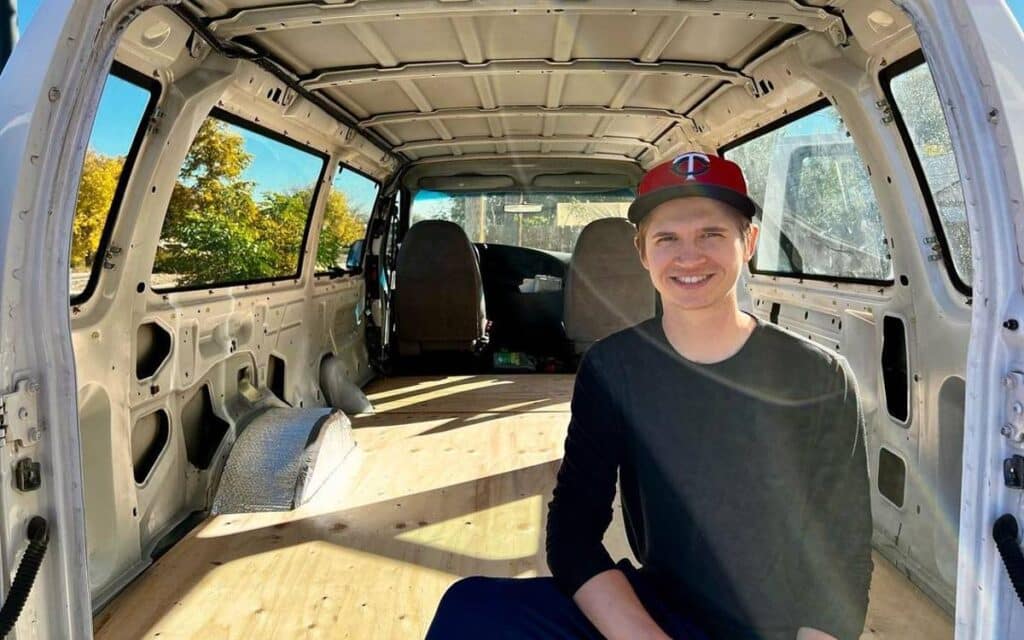 @trevor_backstrom Smiling young man sitting inside a van with its interior stripped down